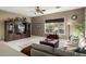 Comfortable living room featuring tiled floors, natural light, a ceiling fan and neutral color palette at 6820 W Angela Dr, Glendale, AZ 85308