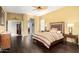 Bedroom with dark wood floors, a ceiling fan, and natural light from the windows at 6820 W Angela Dr, Glendale, AZ 85308
