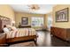 Bedroom with dark wood floors, a ceiling fan, and an area rug at 6820 W Angela Dr, Glendale, AZ 85308