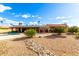 Expansive backyard featuring desert landscaping, a shimmering pool, and a covered patio perfect for outdoor living at 7656 W Wagoner Rd, Glendale, AZ 85308