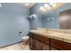 Cozy powder room with tile counters and wood vanity at 7656 W Wagoner Rd, Glendale, AZ 85308