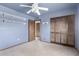 Bedroom featuring a ceiling fan, closet, and built in shelving at 7656 W Wagoner Rd, Glendale, AZ 85308