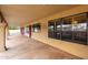 Long covered patio with decorative stone floor, providing ample space for outdoor living and entertaining at 7656 W Wagoner Rd, Glendale, AZ 85308
