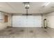 Spacious garage with a white overhead door and smooth concrete floor at 7656 W Wagoner Rd, Glendale, AZ 85308