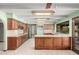 Spacious kitchen with wood cabinets, a center island, and plenty of countertop space at 7656 W Wagoner Rd, Glendale, AZ 85308