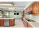 This kitchen features stainless steel appliances, wood cabinetry, and views to the back yard at 7656 W Wagoner Rd, Glendale, AZ 85308
