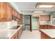 Kitchen featuring wood cabinets, tile backsplash, and modern appliances at 7656 W Wagoner Rd, Glendale, AZ 85308