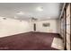 Expansive living room with carpet, recessed lights, and sliding doors at 7656 W Wagoner Rd, Glendale, AZ 85308