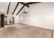 Large living room featuring beamed ceilings and carpeted floors at 7656 W Wagoner Rd, Glendale, AZ 85308