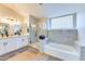 The bathroom features a soaking tub, glass shower, granite dual vanity, and modern fixtures, blending luxury and functionality at 832 N Blue Marlin Dr, Gilbert, AZ 85234