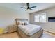 This bedroom boasts light wood floors, a window, and neutral paint offering a serene and inviting ambiance at 832 N Blue Marlin Dr, Gilbert, AZ 85234
