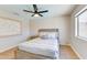 The bedroom offers a serene retreat with neutral walls, a ceiling fan, and a sunlit window, creating a calming ambiance at 832 N Blue Marlin Dr, Gilbert, AZ 85234