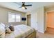 Bright and airy bedroom boasts a ceiling fan and closet, creating a comfortable and convenient space at 832 N Blue Marlin Dr, Gilbert, AZ 85234
