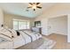 The bedroom's high ceilings and expansive window amplify its light, airy atmosphere, completed with stylish furnishings at 832 N Blue Marlin Dr, Gilbert, AZ 85234