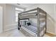 Bedroom with wooden bunkbeds, plush bedding, and ample natural light creates a cozy and inviting space at 832 N Blue Marlin Dr, Gilbert, AZ 85234