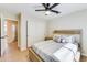 Bright bedroom features a ceiling fan, closet, and an en-suite doorway, providing natural light and convenience at 832 N Blue Marlin Dr, Gilbert, AZ 85234