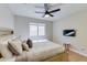 The bedroom includes a neutral color palette, light wood flooring, and a window, for a cozy and well-lit space at 832 N Blue Marlin Dr, Gilbert, AZ 85234