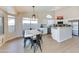 Bright dining area with large windows, modern light fixture, and views to the kitchen and backyard at 832 N Blue Marlin Dr, Gilbert, AZ 85234
