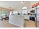 Bright kitchen with white cabinets, granite countertops, stainless steel appliances, and an eat-in dining area at 832 N Blue Marlin Dr, Gilbert, AZ 85234