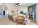 Bright living room with hardwood floors, neutral walls, fireplace, and sliding glass doors leading to the backyard at 832 N Blue Marlin Dr, Gilbert, AZ 85234