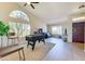 Finished living room with hardwood floors, large arched window and games for entertaining at 832 N Blue Marlin Dr, Gilbert, AZ 85234