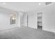 Neutral bedroom with carpet, a large window, and access to a walk-in closet at 8324 W Palo Verde Dr, Glendale, AZ 85305
