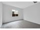 Bright bedroom with gray wood-look flooring and natural light from a window at 8324 W Palo Verde Dr, Glendale, AZ 85305