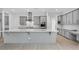 Open kitchen with stainless steel appliances, gray cabinetry, a large island, and subway tile backsplash at 8324 W Palo Verde Dr, Glendale, AZ 85305