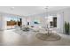 Airy living room with a sliding glass door, neutral furniture, dining table and a decorative rug over the hardwood floors at 8324 W Palo Verde Dr, Glendale, AZ 85305