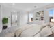 Serene bedroom with neutral decor, bright windows, ensuite bath, and a plant that adds a touch of nature at 8324 W Palo Verde Dr, Glendale, AZ 85305
