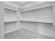Walk-in closet features carpet flooring, white walls, and plenty of shelving at 8324 W Palo Verde Dr, Glendale, AZ 85305