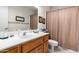A half bathroom features a single sink vanity with oak cabinets and a toilet at 8336 E Neville Ave, Mesa, AZ 85209
