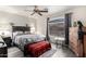 A cozy bedroom features a gray wood bed frame, neutral walls, wood-look flooring, and a ceiling fan at 8336 E Neville Ave, Mesa, AZ 85209