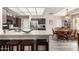 Bright kitchen with granite countertops, stainless steel appliances, bar seating, and an adjacent dining area at 8336 E Neville Ave, Mesa, AZ 85209