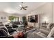 Bright living room with a vaulted ceiling, ceiling fan, large window, and comfortable seating arrangement at 8336 E Neville Ave, Mesa, AZ 85209