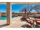 Inviting covered patio overlooking the pool with outdoor dining and BBQ area, perfect for entertaining and relaxation at 8377 S Mountain Air Ln, Gold Canyon, AZ 85118