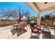 Covered patio with an outdoor dining setup and a BBQ grill, ideal for enjoying outdoor meals and gatherings at 8377 S Mountain Air Ln, Gold Canyon, AZ 85118