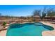 Wonderful backyard with a pool, covered patio, and well-maintained landscaping, perfect for outdoor living and entertaining at 8377 S Mountain Air Ln, Gold Canyon, AZ 85118