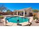 Beautiful backyard featuring a pool, covered patio, and desert-friendly landscaping, perfect for relaxation and recreation at 8377 S Mountain Air Ln, Gold Canyon, AZ 85118