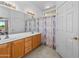 Bright bathroom featuring a double sink vanity, tiled floors, and a shower at 8377 S Mountain Air Ln, Gold Canyon, AZ 85118