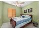 Cozy bedroom with green walls, fan, and natural light at 8377 S Mountain Air Ln, Gold Canyon, AZ 85118