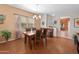 This dining room features a chandelier, wood floors, and seating for four around a table with tile inserts at 8377 S Mountain Air Ln, Gold Canyon, AZ 85118