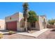 Front exterior featuring desert landscaping, neutral paint, and a red garage door at 8377 S Mountain Air Ln, Gold Canyon, AZ 85118