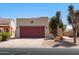 Charming home with a red garage door and desert landscaping offers great curb appeal at 8377 S Mountain Air Ln, Gold Canyon, AZ 85118