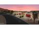 Street view of charming homes with well-maintained yards and desert landscaping at sunset at 8377 S Mountain Air Ln, Gold Canyon, AZ 85118