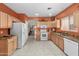 Bright kitchen featuring granite countertops, ample storage, white appliances, and a breakfast bar at 8377 S Mountain Air Ln, Gold Canyon, AZ 85118