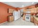This open kitchen features granite counters, white appliances, and ample storage at 8377 S Mountain Air Ln, Gold Canyon, AZ 85118