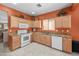 Well-equipped kitchen featuring granite countertops, white appliances, and wooden cabinets at 8377 S Mountain Air Ln, Gold Canyon, AZ 85118
