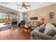 The spacious living room is bathed in natural light, with a ceiling fan, wood floors, and sliding door at 8377 S Mountain Air Ln, Gold Canyon, AZ 85118