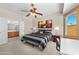 Comfortable primary bedroom featuring carpet floors, fan, and en-suite bathroom at 8377 S Mountain Air Ln, Gold Canyon, AZ 85118